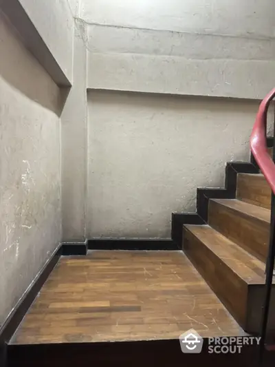 Well-maintained wooden staircase in a modern residential building, showcasing the durable materials and solid construction.