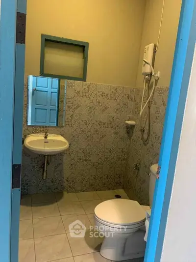Cozy bathroom with modern fixtures and stylish tile design, perfect for a compact living space.