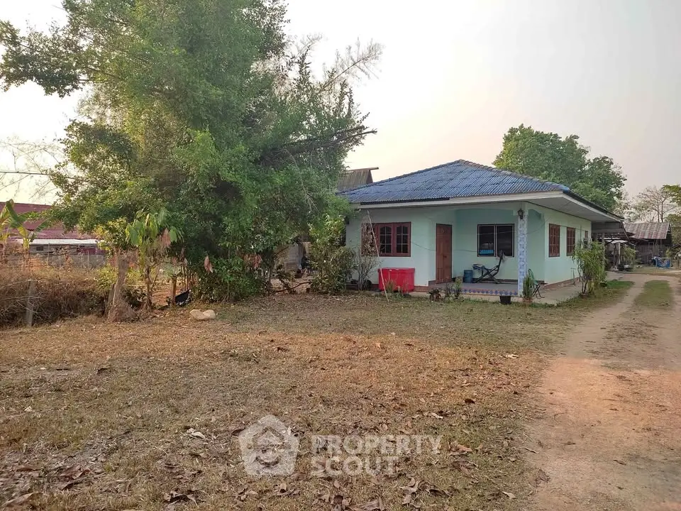Charming countryside home with spacious yard and lush greenery, perfect for tranquil living.