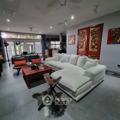 Spacious living room with elegant decor and large windows for natural light.