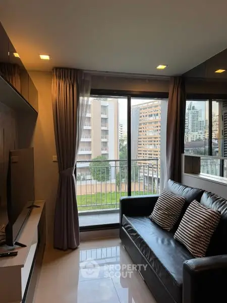 Modern living room with city view and sleek black sofa