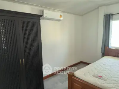 Cozy bedroom with air conditioning and wardrobe, perfect for comfortable living.