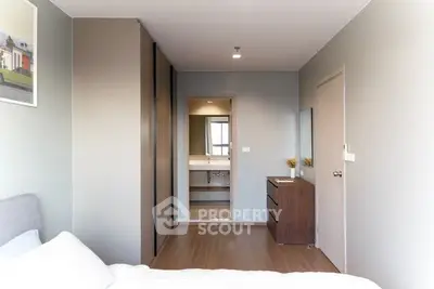Modern bedroom with ensuite bathroom and sleek storage solutions