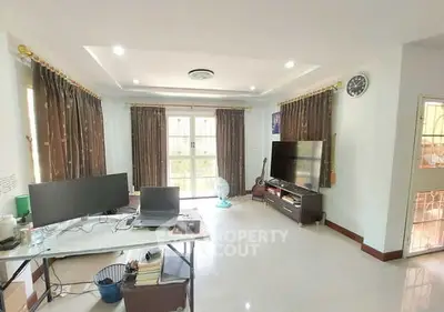 Spacious living room with modern decor and large windows for natural light.