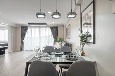 Modern dining area with elegant decor and natural light in a spacious living room.
