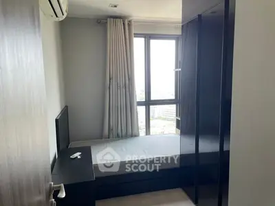 Modern bedroom with large window and sleek furniture in high-rise apartment