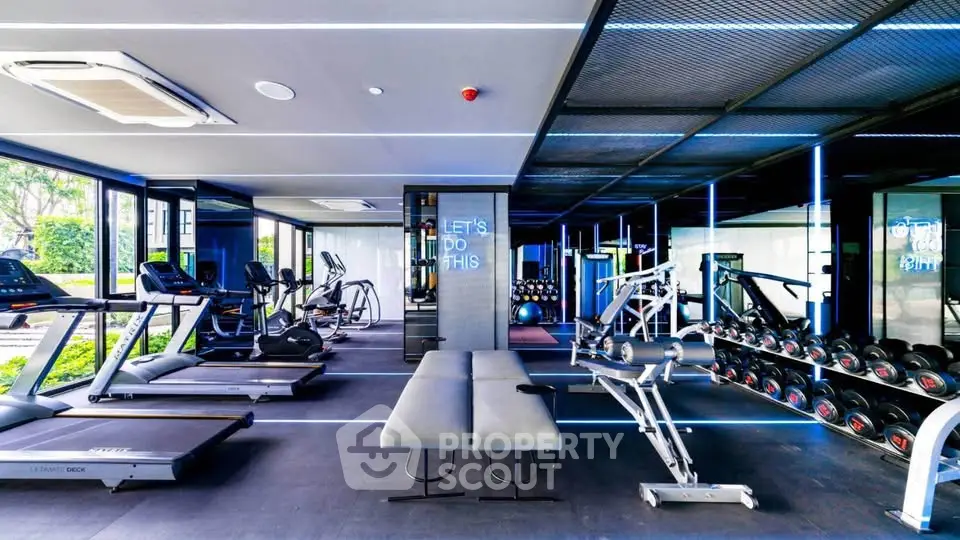 Modern gym with state-of-the-art equipment and sleek design in luxury real estate property.