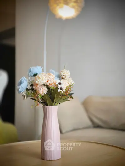 Elegant living room with stylish floral arrangement and cozy seating area.