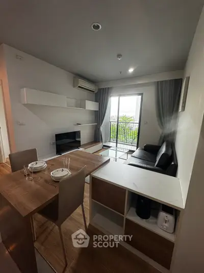 Modern living room with balcony view, sleek furniture, and stylish decor.