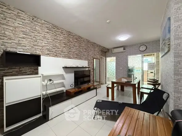 Modern living room with stylish decor and open layout, featuring a cozy seating area and dining space.