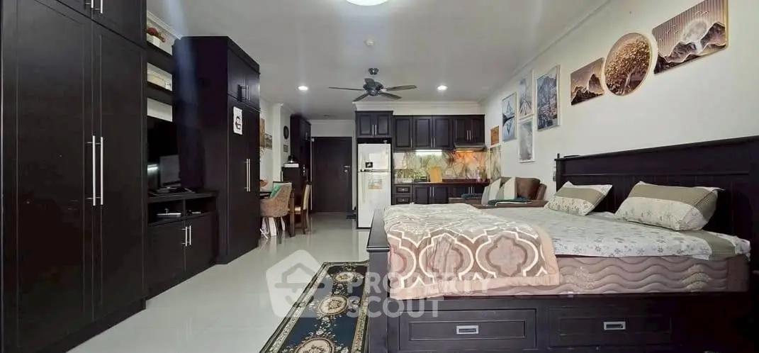 Spacious studio apartment with modern kitchen and cozy bedroom area, perfect for urban living.