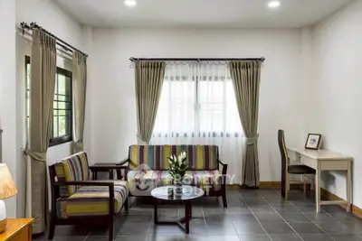 Charming living room with stylish furniture and natural light, perfect for relaxation.