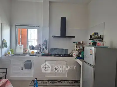 Charming kitchen with modern appliances and ample natural light, perfect for culinary enthusiasts.