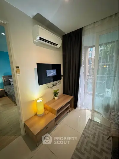 Modern living room with air conditioning and balcony access in stylish apartment.