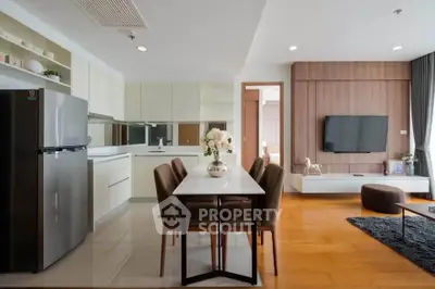 Modern open-layout living room and kitchen with sleek design and elegant dining area.
