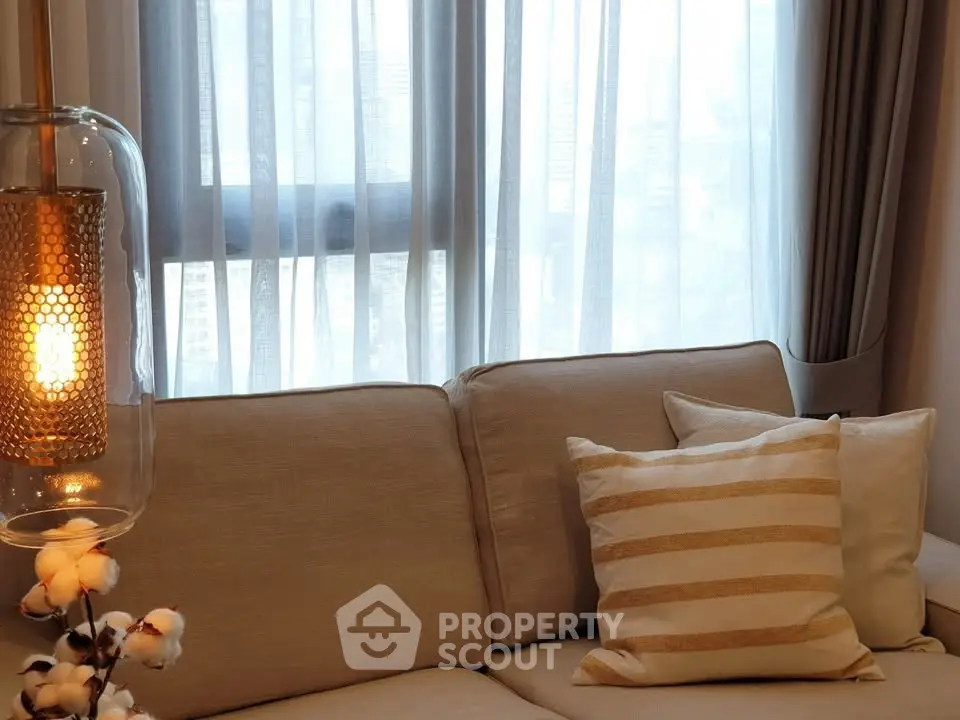 Cozy living room with elegant sofa and soft lighting, perfect for relaxation.
