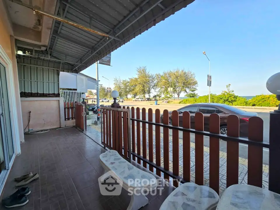 Charming outdoor patio with ocean view and cozy seating area, perfect for relaxation.