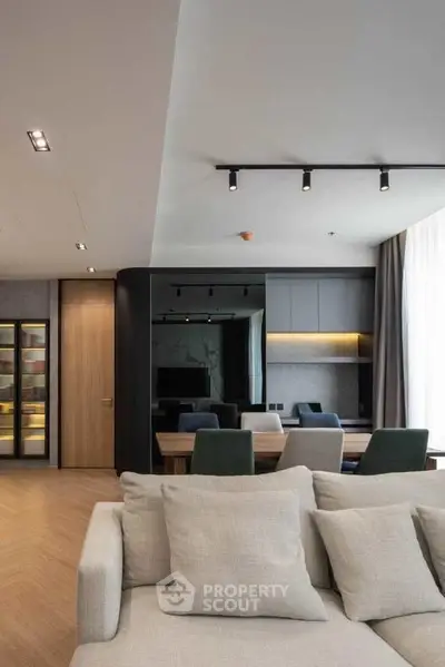 Modern living room with elegant dining area and stylish lighting in a contemporary apartment.