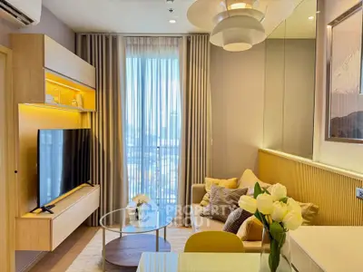 Modern living room with stylish decor and large TV, featuring floor-to-ceiling windows and elegant lighting.