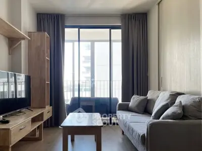 Modern living room with natural light and balcony access