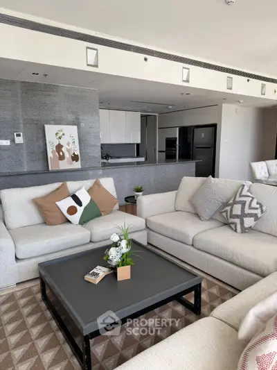 Spacious modern living room with elegant decor and open kitchen layout