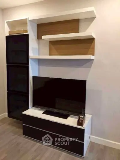 Modern living room with sleek TV unit and stylish shelving