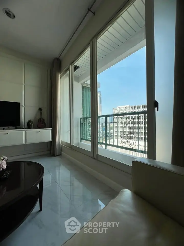 Spacious living room with large windows offering stunning city views