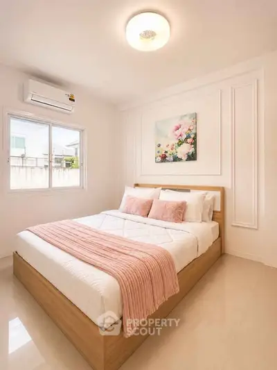 Cozy bedroom with modern decor and natural light, featuring a stylish bed and elegant wall art.