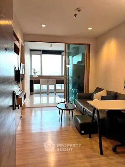 Modern living room with sleek furniture and open view, perfect for urban living.