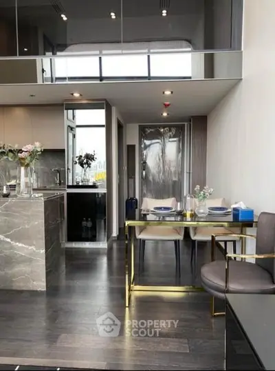 Modern open-plan living and dining area with sleek kitchen and stylish decor.