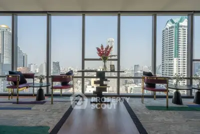 Luxurious high-rise living room with panoramic city views and elegant decor.