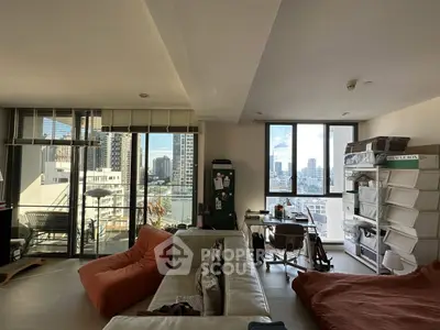 Spacious living room with city view and balcony access in modern apartment