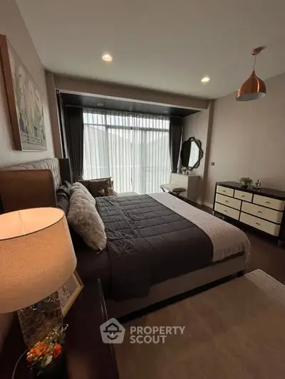 Elegant bedroom with modern decor and large window for natural light