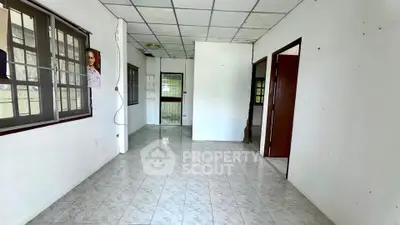 Spacious interior with tiled flooring and large windows, ideal for customization.
