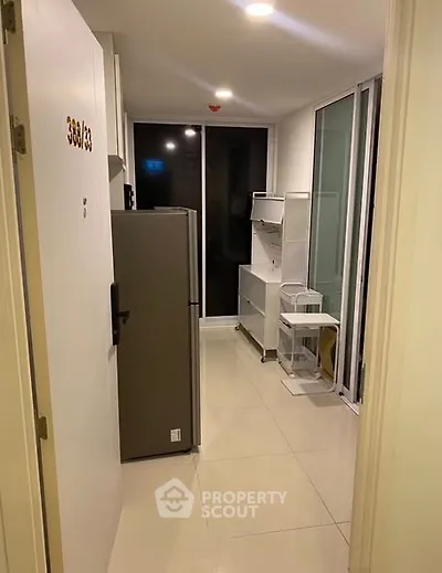 Compact kitchen with modern appliances and sleek storage solutions.