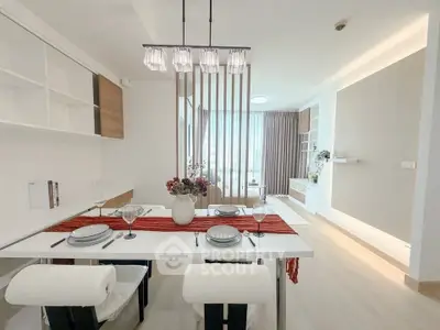 Modern dining area with elegant decor and natural light in a stylish apartment.