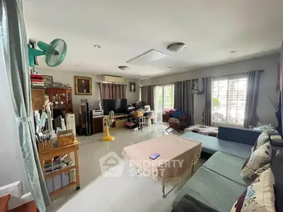 Spacious living room with modern decor and ample natural light