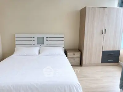 Modern bedroom with sleek wardrobe and cozy bed in a bright apartment.