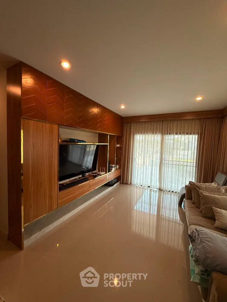 Elegant living room with modern entertainment center and large window