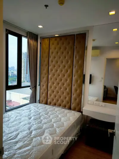 Modern bedroom with city view and stylish padded headboard