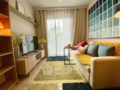 Cozy living room with modern decor, large window, and stylish furniture in a contemporary apartment.