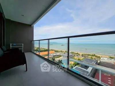 Stunning beachfront balcony with panoramic ocean views and modern glass railing.