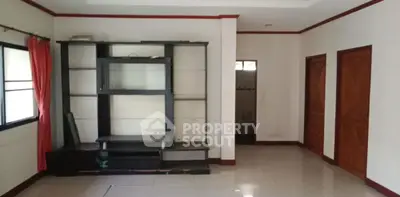 Spacious living room with built-in entertainment unit and large windows.