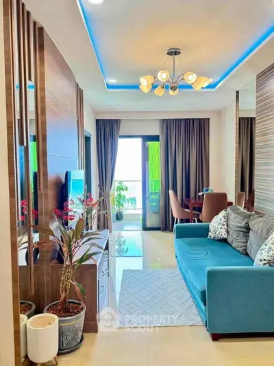 Modern living room with blue sofa, stylish lighting, and balcony view in a contemporary apartment.
