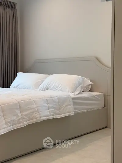 Modern bedroom with elegant bed and soft lighting, perfect for relaxation and comfort.