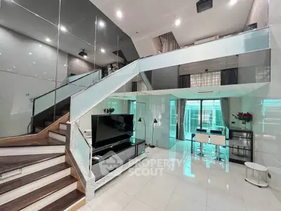 Luxurious modern living room with high ceilings and stylish glass staircase
