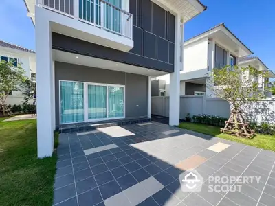 Modern two-story house with spacious driveway and lush garden