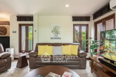 Spacious living room with modern decor and large windows for natural light