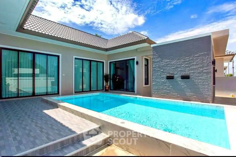 Luxurious modern villa with private pool and elegant architecture under a clear blue sky.