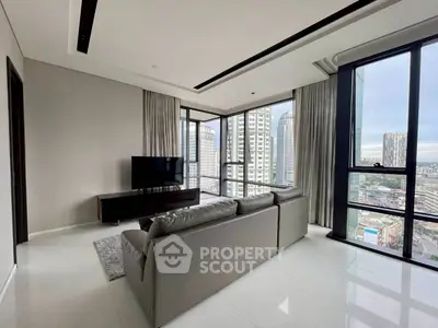 Luxurious high-rise living room with stunning city views and modern furnishings.